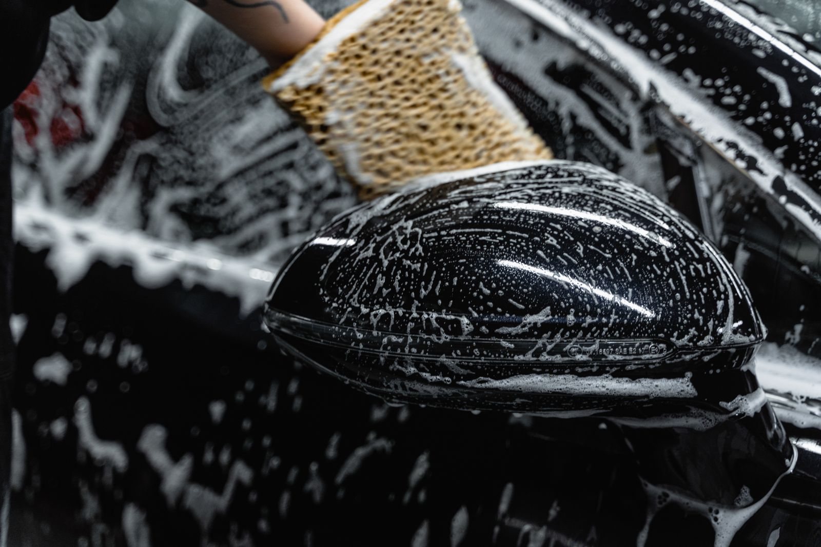Soap being worked across a vehicle exterior